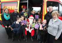 Santa swaps his sleigh for a fire engine at Princetown Primary School