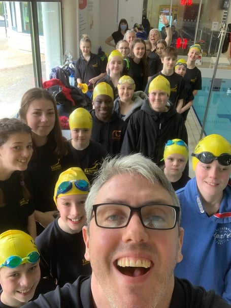 Tavistock Swimming Club head coach James Lake with swimmers and poolside helpers ready for the afternoon session at the annual sprint meet at Parklands Leisure Centre