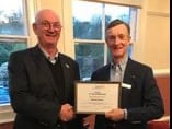 Robin Wilson is presented with a certificate for 40 years service to the Rotary by Tavistock club president Nigel Ellis