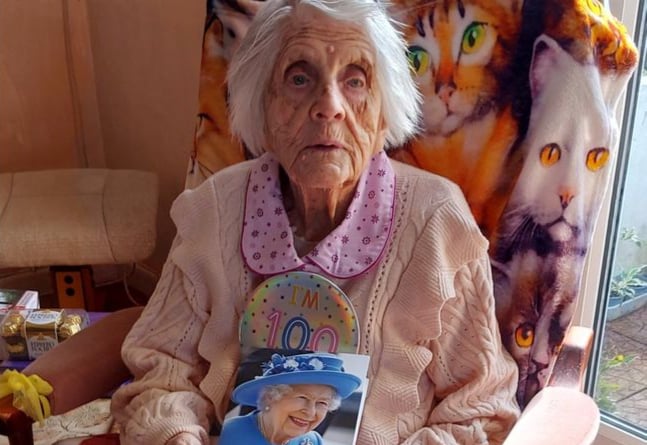Queenie Collings with her card from the Queen on her 100th birthday