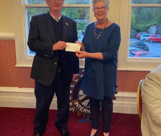 Club President Nigel Ellis presenting Joy Harrison with a cheque for £1,500