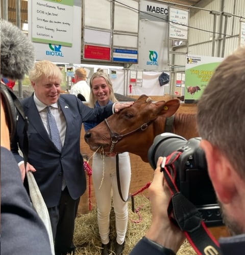 Abi Marshall with her champion cow and Prime Minister Boris Johnson
