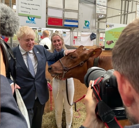 Abi Marshall with her champion cow and Prime Minister Boris Johnson