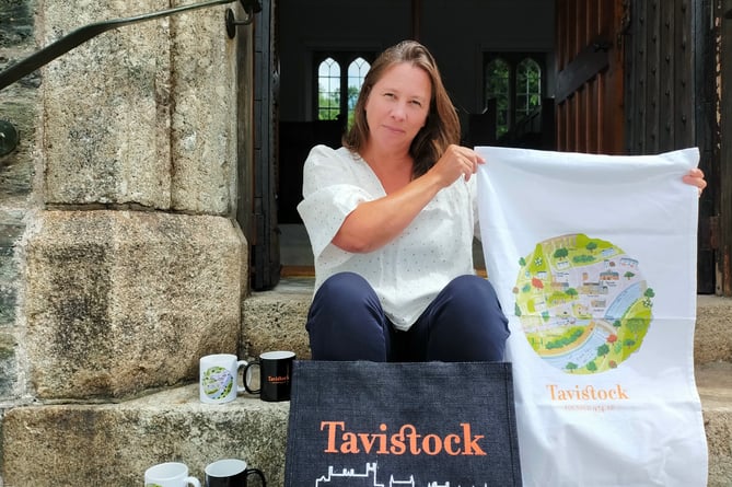BID Manager Janna Sanders holds official Visit Tavistock merchandise, 