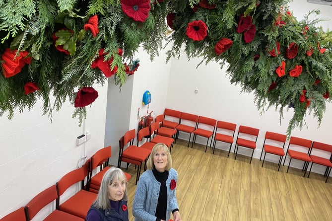 Anne Worden  and Irene Jordan admire villagers’  handiwork: Broadwidger village giant poppy garland opens  this Saturday for the Poppy Appeal