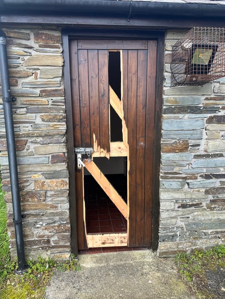 Damage that occurred to the cemetery toilet door.