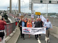Hundreds march against toll charges