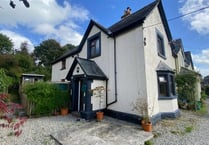 "Charming" cottage for sale has panoramic views and a woodland garden