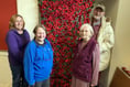 Children and villagers unite to remember with poppy creations