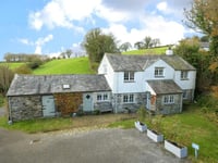 "Charming" cottage for sale sits beside stream with countryside views