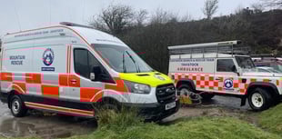Volunteer rescuers help a stuck runner