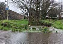 Tavistock car park's entrance floods as rain continues