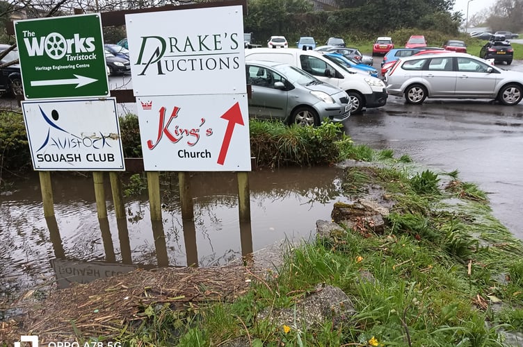 Heavy rain is causing the stream alongside Pixon Lane to flood the car park entrance.
