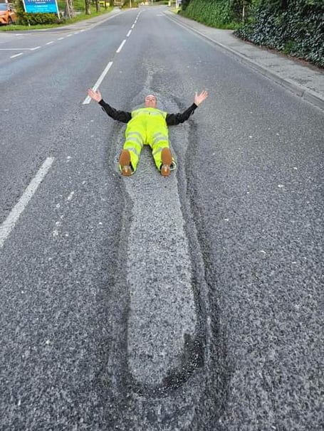 The largest pothole in Tavistock - on Plymouth Road - swallows up campaigner David Newcombe. 
