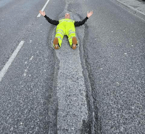 The largest pothole in Tavistock - on Plymouth Road - swallows up campaigner David Newcombe. 