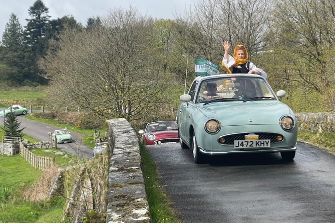 Nissan Figaro car owners touring Devon raising smiles at its retro style.