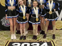 Cheerleaders bring gold home to Okey