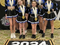 Cheerleaders bring gold home to Okey