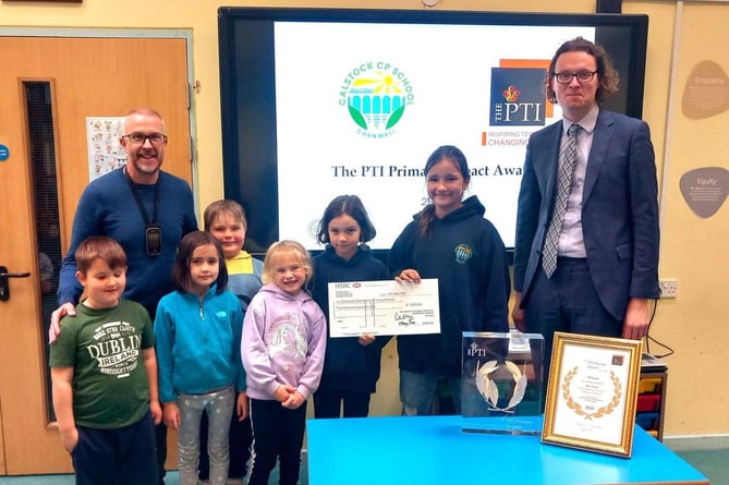 Calstock School Headteacher Ben Towe and pupils receive their teaching award from PTI Chief Operating Officer Patrick Wigg.