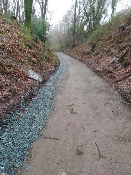 Smooth Tamar Trails path after being repaired with steep natural banks either side.
