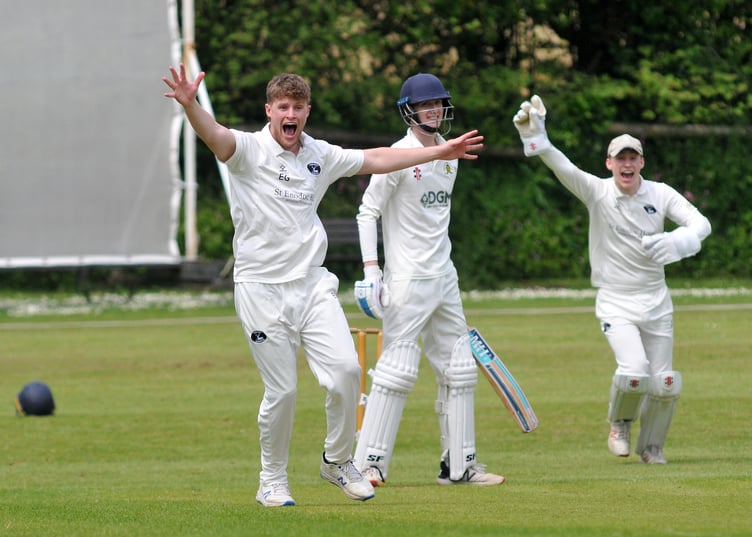 Devon Cricket League A Division.  Abbotskerswell versus Bridestowe. Bridestowe bowler  Etahn Guest and 'keeper Patrick Ewen are vocal in their appeal for lbw - but Abbotskerwell batsman James Tyler is safe for now