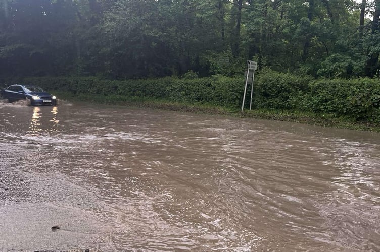The main road to Mary Tavy past Toll House turned into a temporary river by the flash flood.