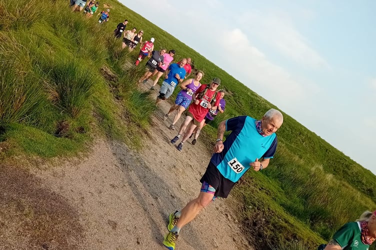 A Plymouth Musketeers Running Club. member heads the firefighter trail run from Princetown.