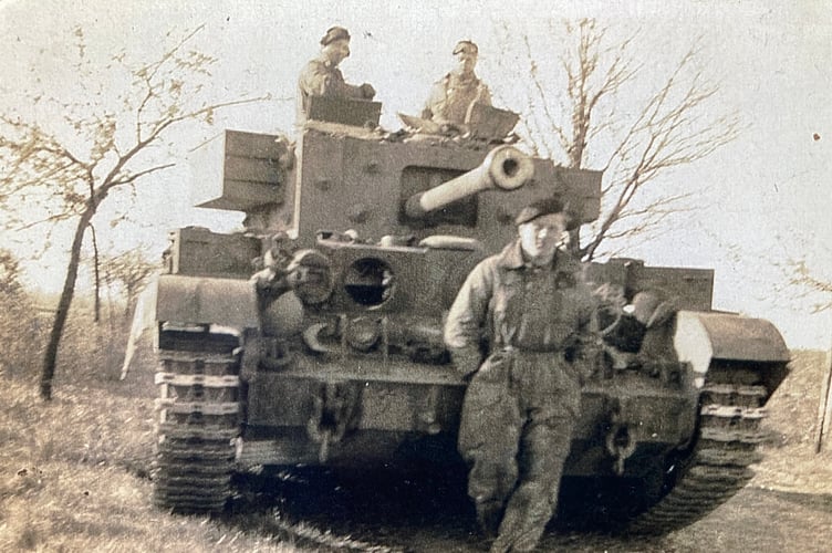 Richard Aldred in front of his Army tank during the Battle of Normandy backing up D-Day forces.