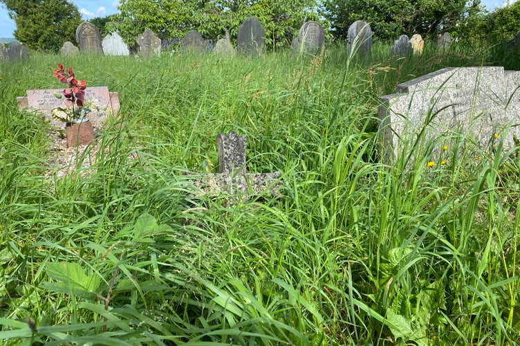 Bere Aston overgrown churchyard is due for a cut.