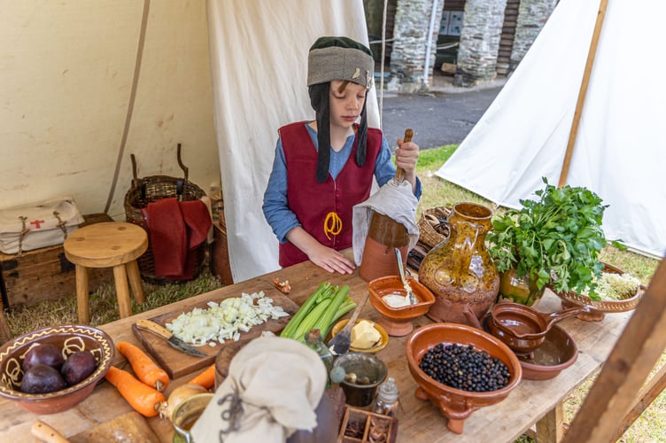 A boy joins in the Medieval activities at Buckland Abbey's Fathers' Day event.