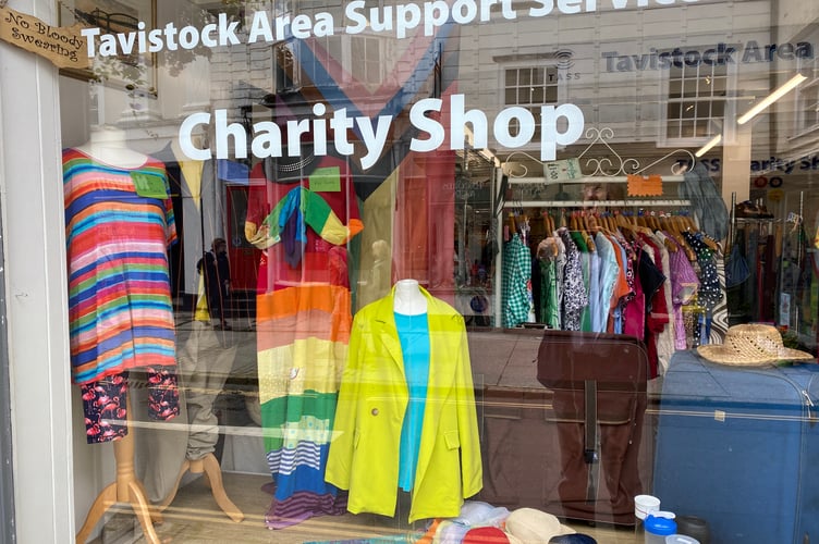 Tavistock Area Support Services charity shop supports the town's pride event with rainbow clothes on sale.