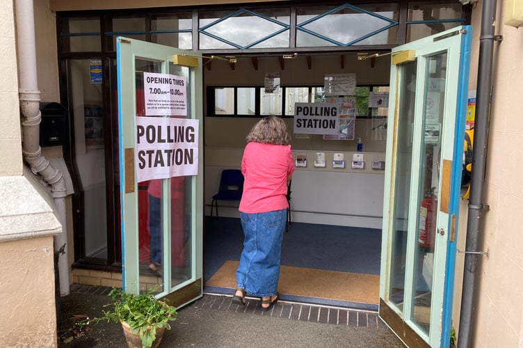 Voters at the General Election polling station in Tavistock Methodist Church today.