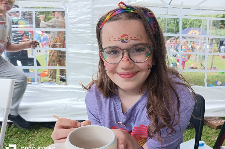 Rosie, from Princetown, is inspired to decorate pots at Tavi Pride festival.