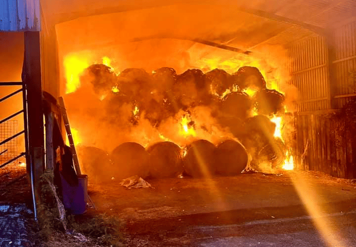 Lawhitton hay well alight in farm barn before firefighters attended