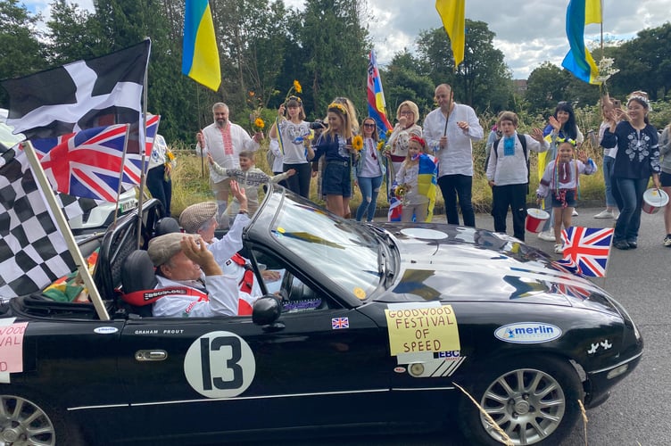The Ukrainian community applaud a dressed-up classic car at Tavistock Carnival.
