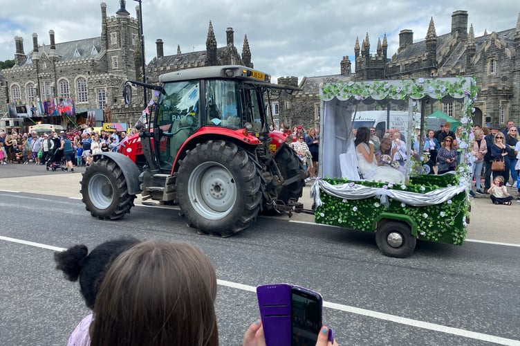 Bere Alston Carnival Queen Ruby and Princess Amber applauded by the crowds in Bedford Square.