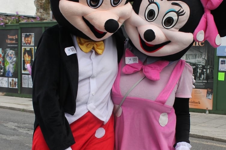 Mickey Mouse and Minnie Muse helping raise an impressive total of cash from carnival spectators for the Lions community projects.