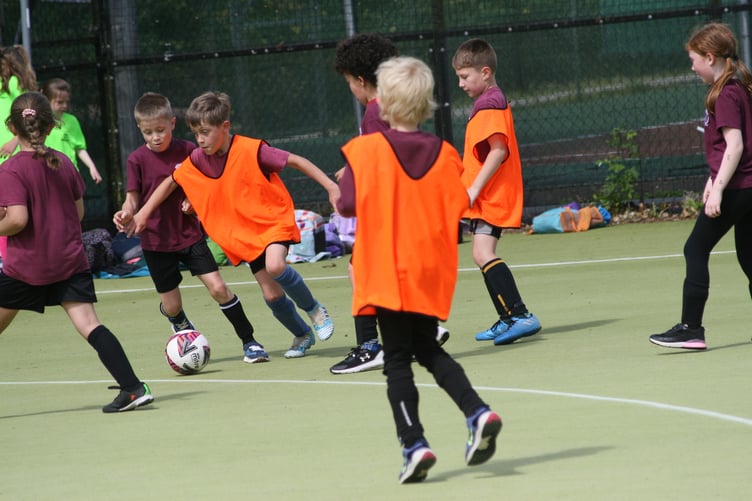 Dribbling past the defenders at West Devon Primary Schools Mixed Football Tournament. JPG