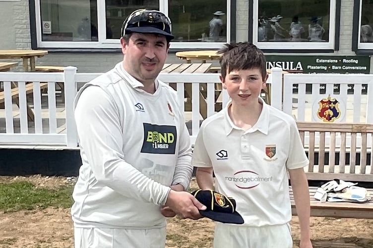 Tavistock's up-and-coming bowler Nelson Stanley being presented with his club cap by 2nd XI captain Marc Lewis. Stanley (13) took four wickets in the win over Chagford