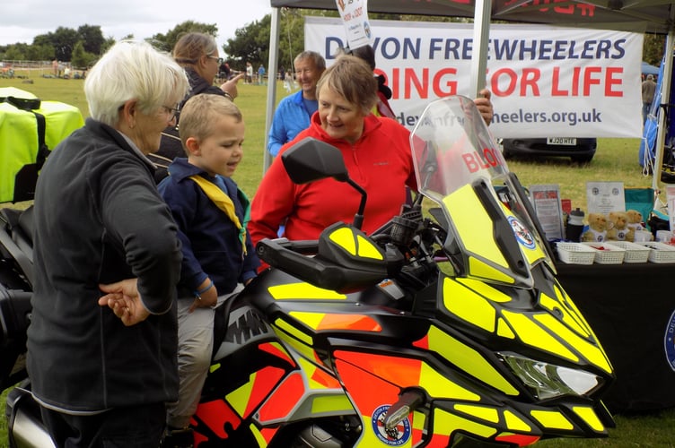 Not too young to ask questions - learning all about blood bikes at Yelverton Rotary's Crafts and Fun Day