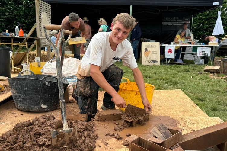 Demonstrating making cob bricks, one of the many traditional activities demonstrated at the Chagford Show.  AQ 0620