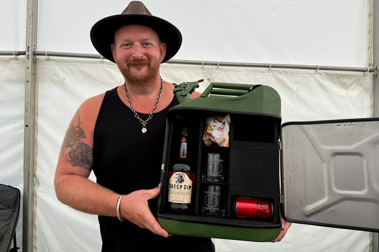 Gregory Gosden from Wild Cabin Creations of Chagford had a stall featuring his engraved wood carving and upcycled metal products, including his bar in a jerry can, which proved popular.  AQ 0702