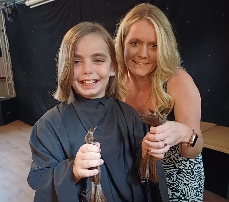 Amelia Trapp, eight, with her hairdresser Emilie Welch and her hair