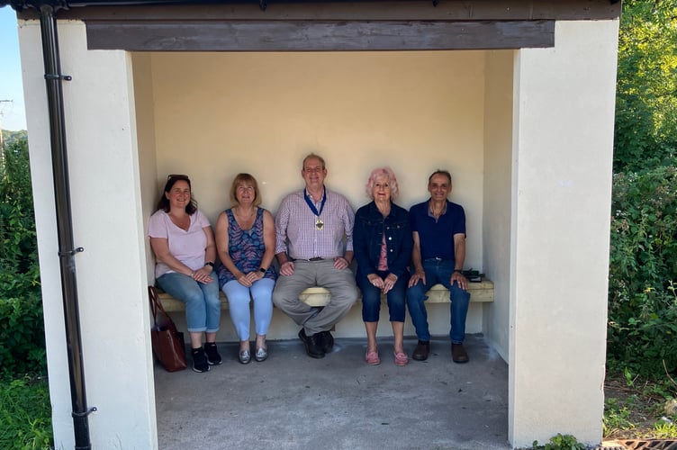 Plasterdown Parish Council members in the revamped bus shelter at Grenofen