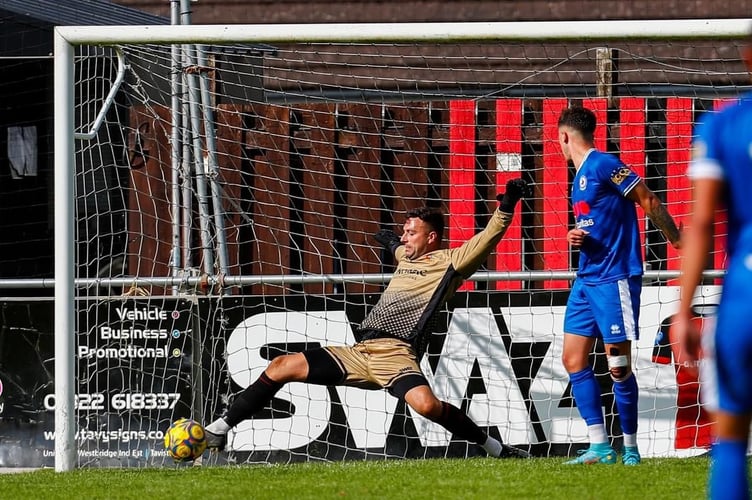 Tavi goalkeeper Aaron Dearing makes an athletic stop