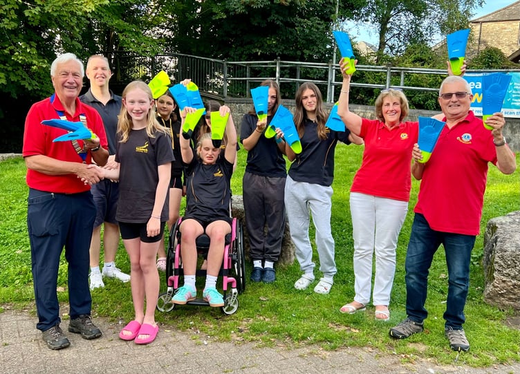 The Tavistock Lions with young swimmers at Tavistock Swimming Club - their donations has paid for fabulous fins to help swimmers learn the basics in the pool