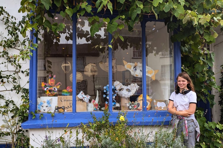 Lola with exhibition in window of Ruth Smith Gallery, North Tawton