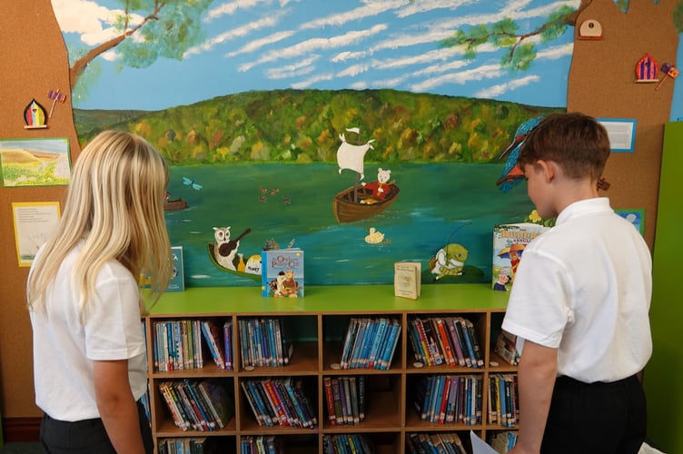 The children admire the library murals