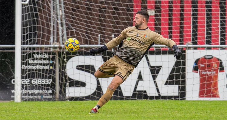 Tavi goalkeeper Aaron Dearing strikes