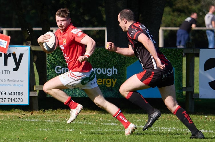 Tavistock centre Liam Watts (right) cannot catch Barnstaple wing Alex MacMillan as he races away for one of his five tries in the game at Pottington Road